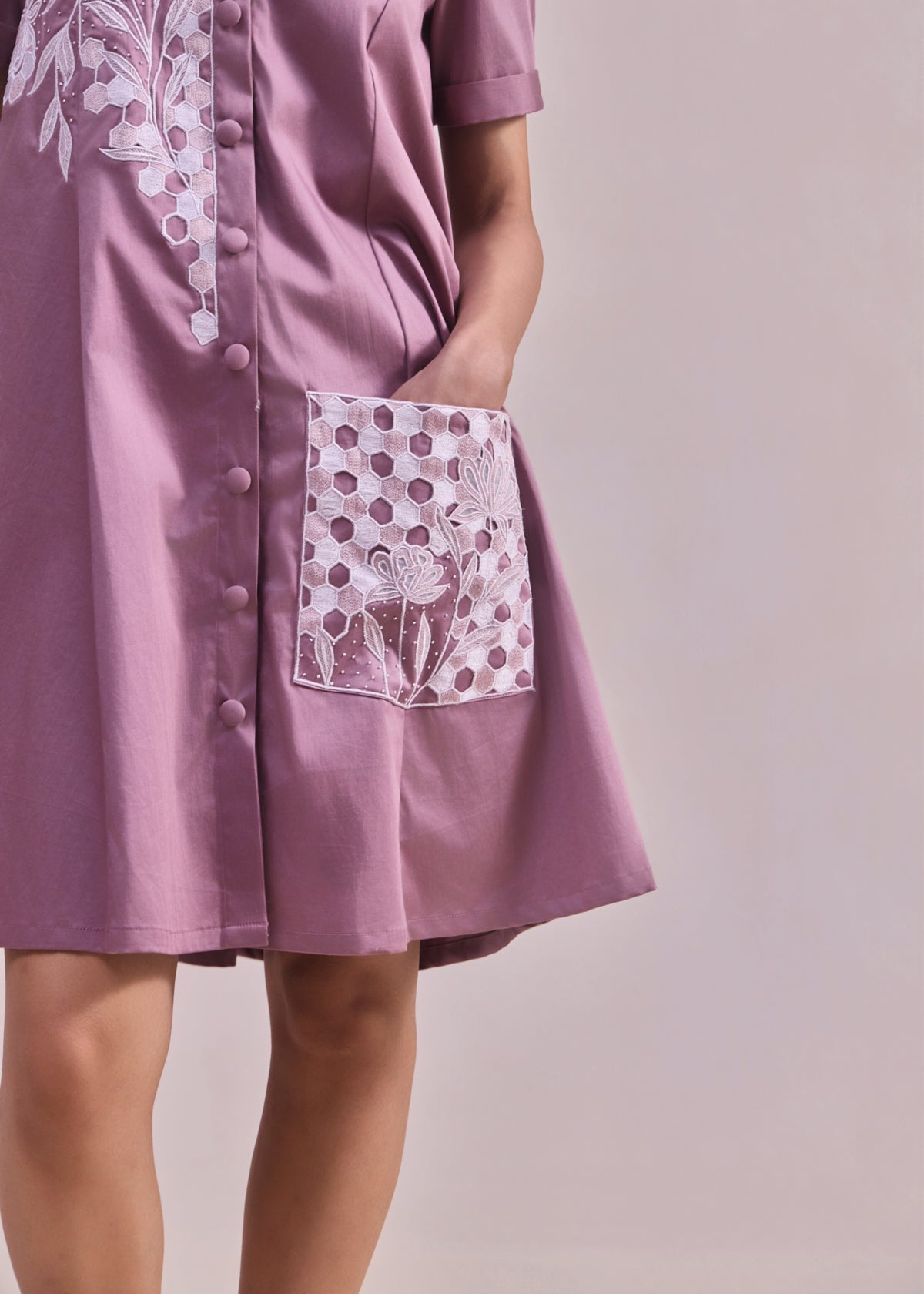 Purple dress with white floral patterns on a plain background